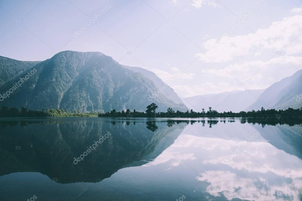 Still mountain lake with soft light and calm reflections