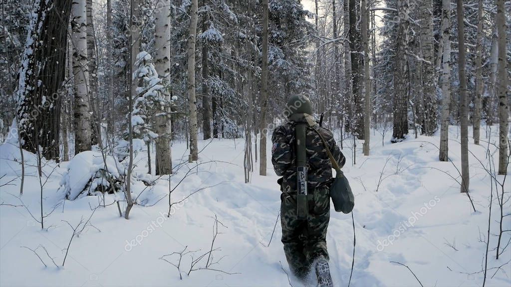 Guide and guest walking with packs through native forest