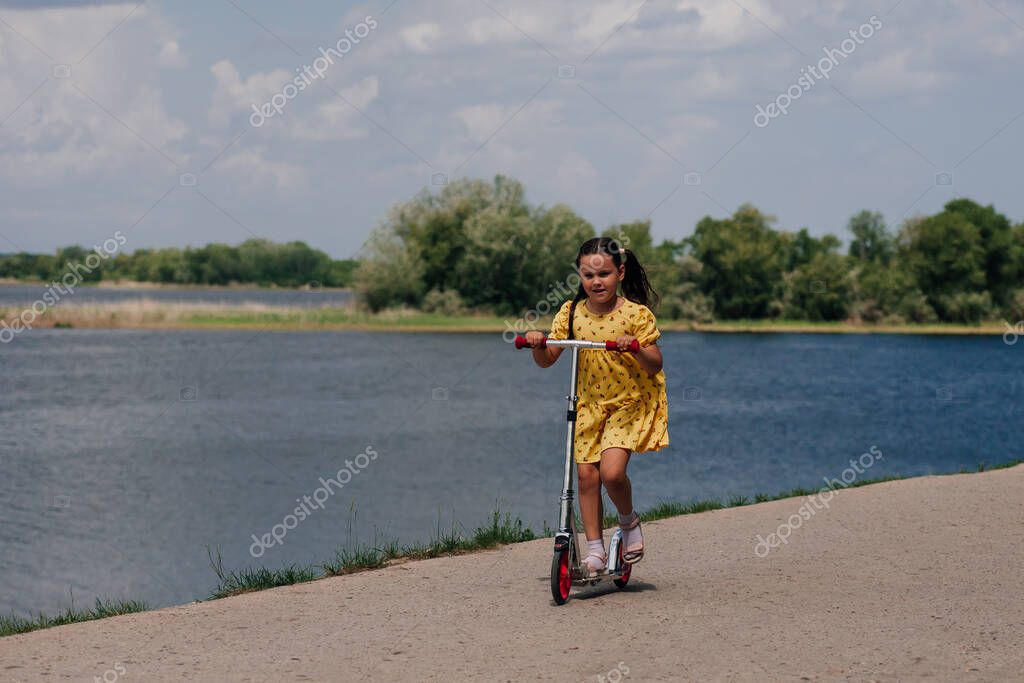 Family walking together on a riverbank trail