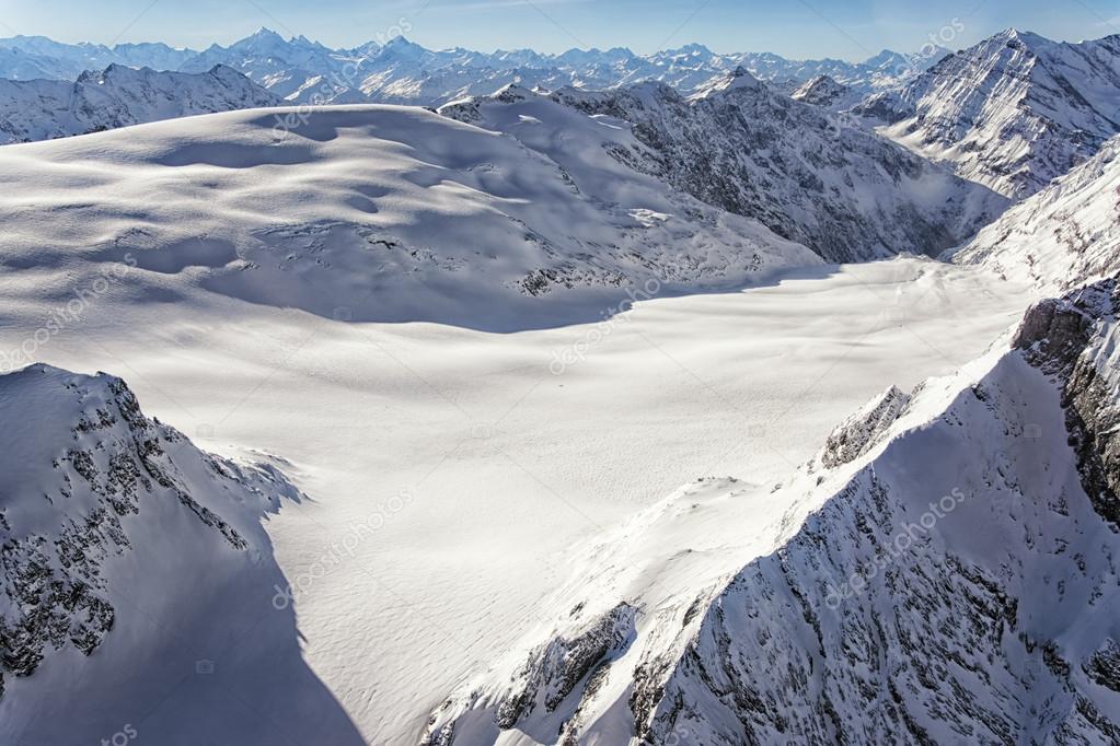 Helicopter and hikers on an alpine ridge with wide views