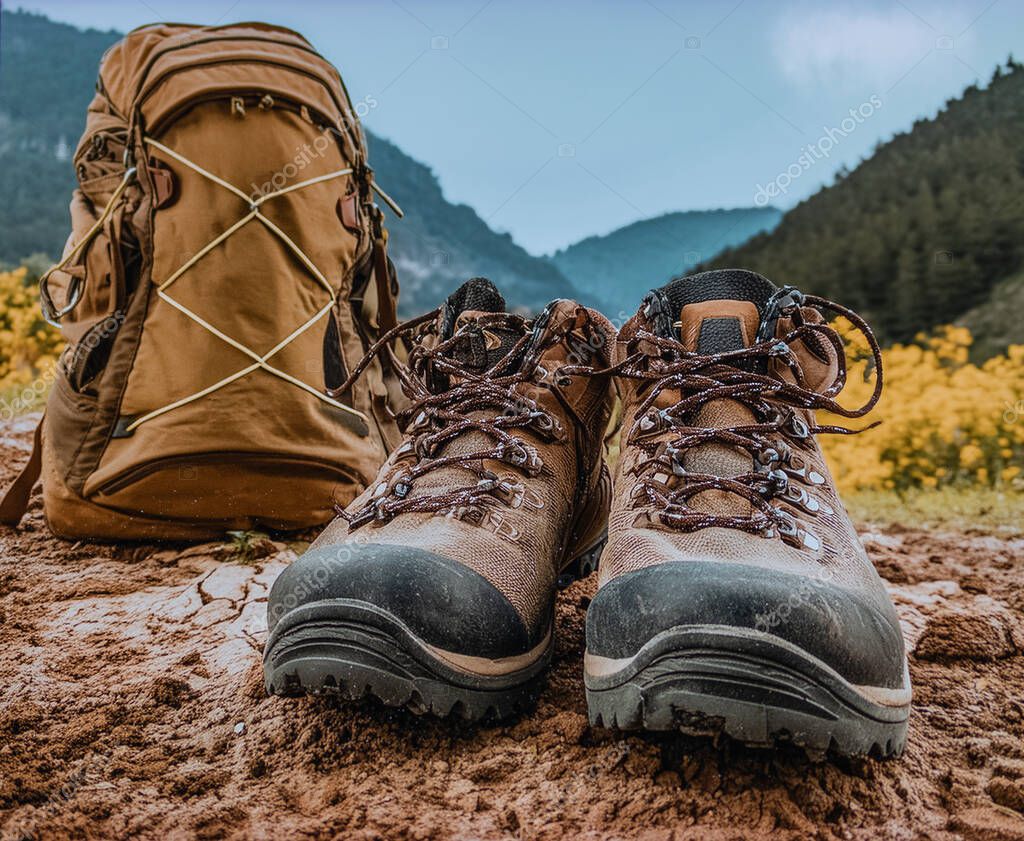 Backpack and boots laid out before a mountain trip