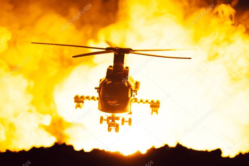 Helicopter departing from an alpine ridge after dropping hikers at their start point.