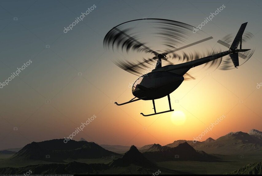 Helicopter silhouette against a colourful sunset sky on return to base.