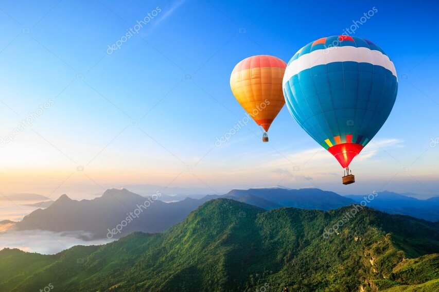 Aerial view over a deep blue lake and steep mountains during a scenic flight.