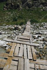 Clear river flowing over stones with mountains in the distance