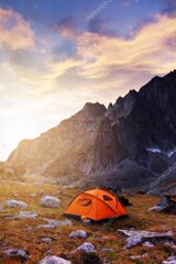 Warm sunset light over a quiet camp in the mountains